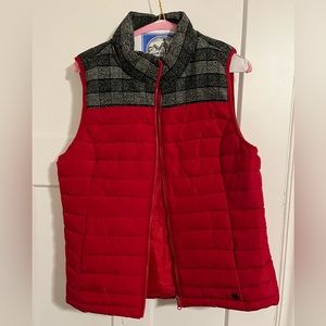 Red puffer vest with accent plaid material.